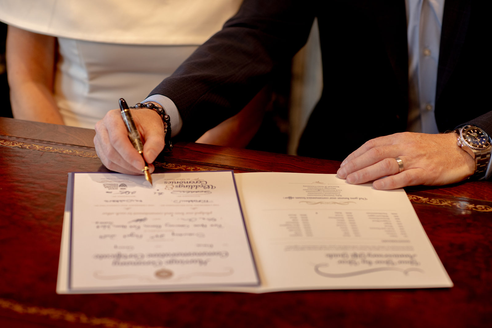 A groom signing the wedding register