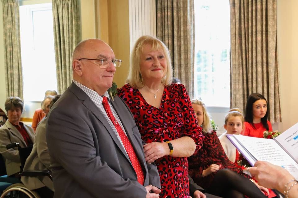 A couple standing together during an intimate register office ceremony
